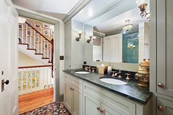 a bathroom with a granite countertop sink a mirror and a shower