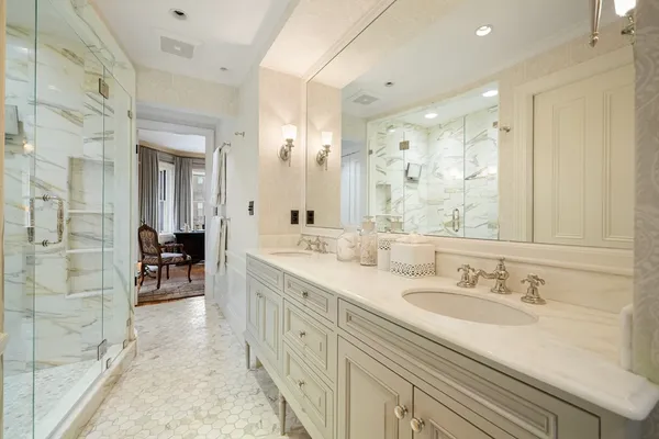 a spacious bathroom with a granite countertop sink a mirror a vanity and shower