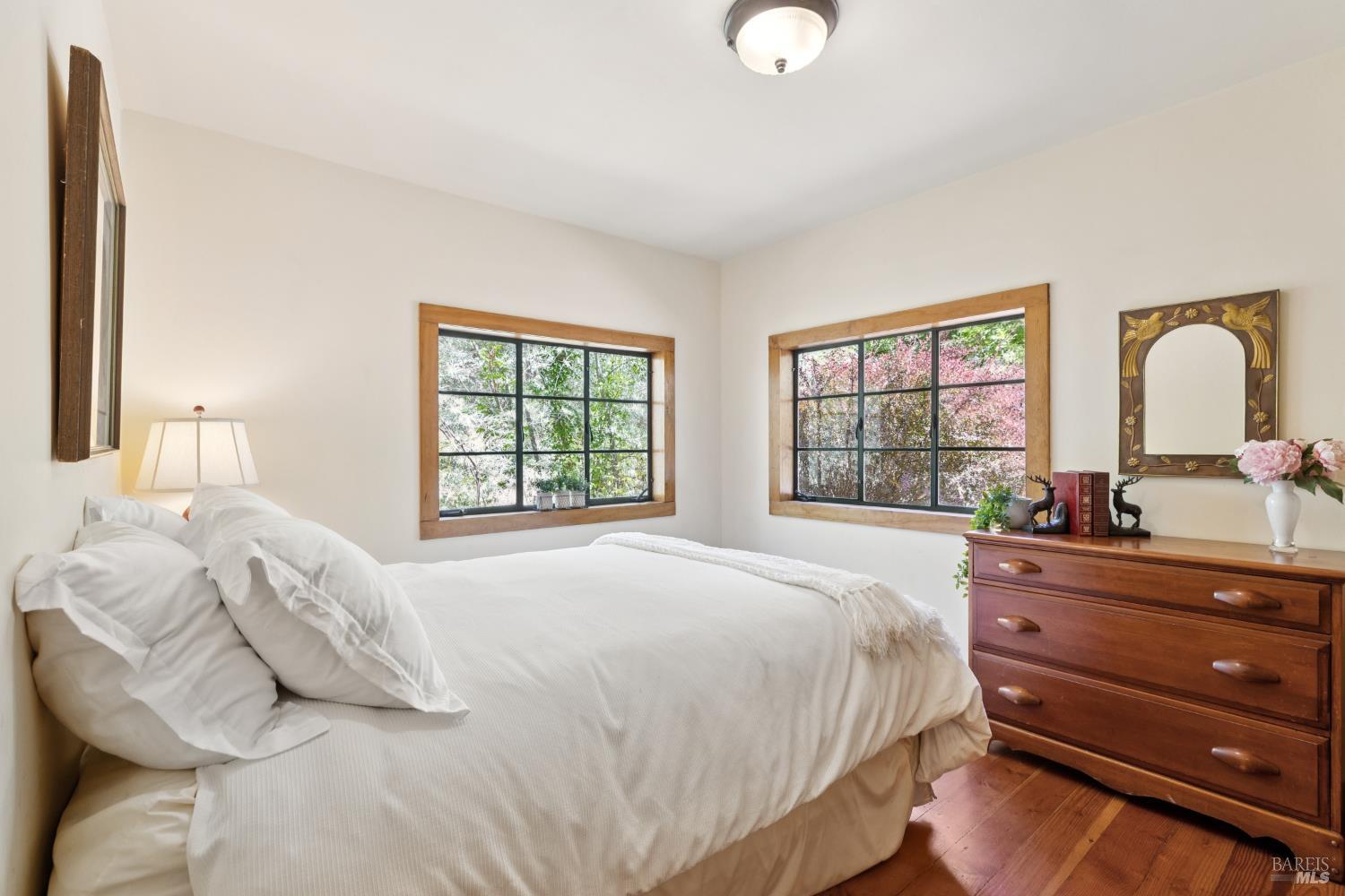 1311 West Dry Creek Road Healdsburg, CA 95448 - Photo 18 of 37 a bedroom with a bed and a dresser with mirror