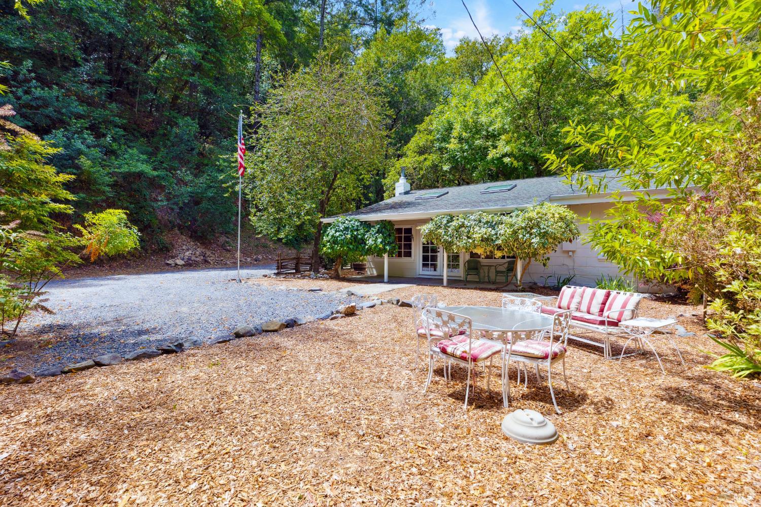 1311 West Dry Creek Road Healdsburg, CA 95448 - Photo 4 of 37 a view of backyard with table and chairs under an umbrella