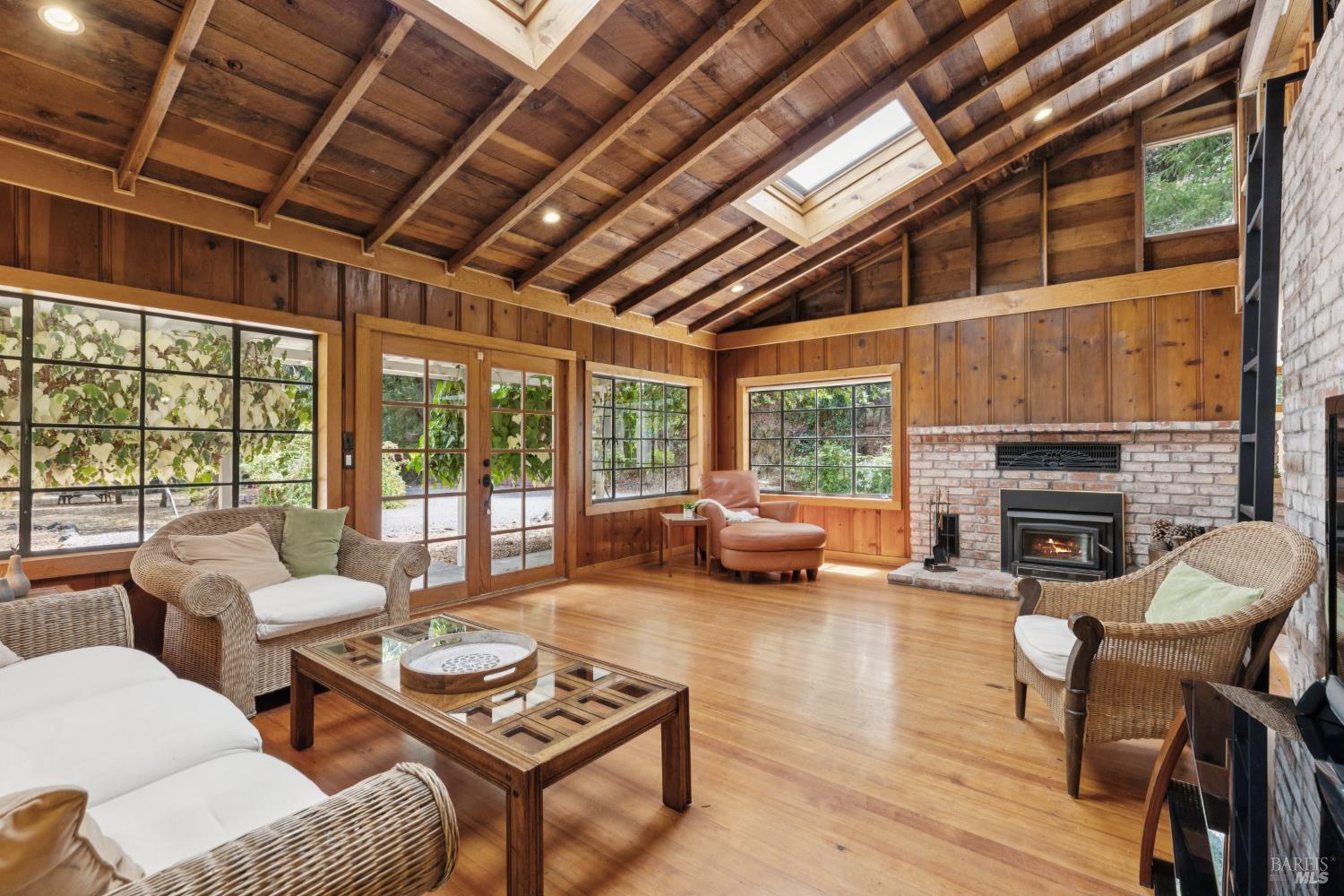 1311 West Dry Creek Road Healdsburg, CA 95448 - Photo 7 of 37 a living room with furniture a fireplace a table and a table