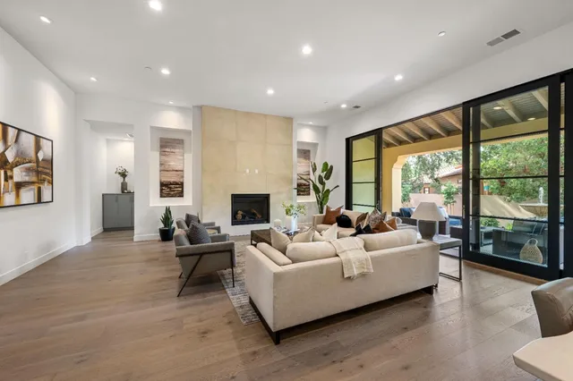 a living room with furniture and large windows