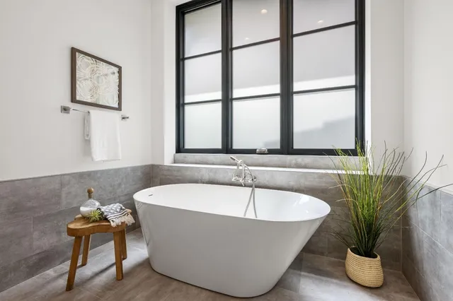 a white bath tub sitting next to a window