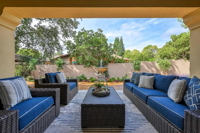 a outdoor living space with furniture and a fireplace