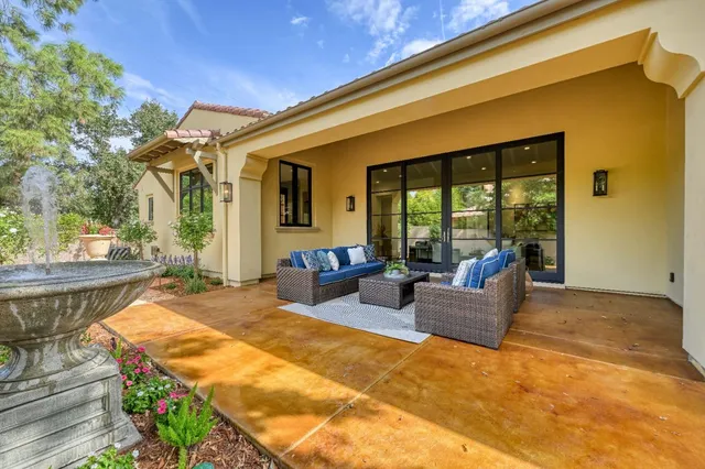 a living room with furniture and a floor to ceiling window