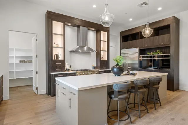 a kitchen with stainless steel appliances kitchen island a large island in the center