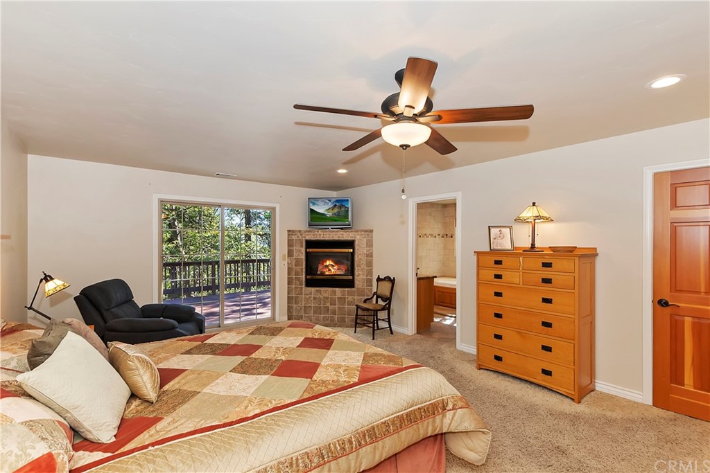 24310 Albrun Drive Crestline, CA 92325 - Photo 16 of 39 a bed room with a bed and a chandelier