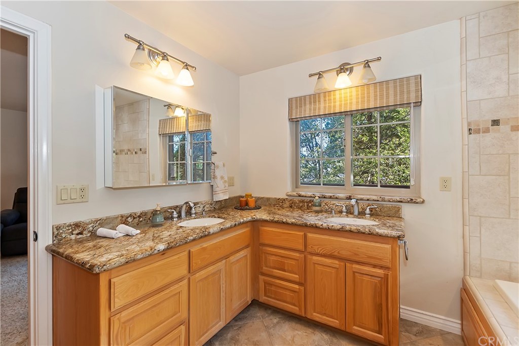 24310 Albrun Drive Crestline, CA 92325 - Photo 18 of 39 a bathroom with a sink and a mirror
