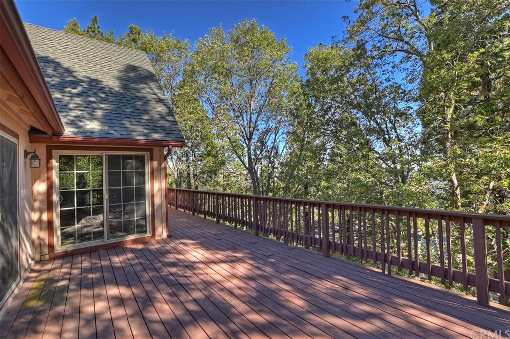 24310 Albrun Drive Crestline, CA 92325 - Photo 31 of 39 a view of backyard with large trees and wooden fence