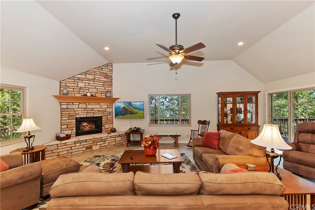 24310 Albrun Drive Crestline, CA 92325 - Photo 5 of 39 a living room with furniture fireplace and a large window