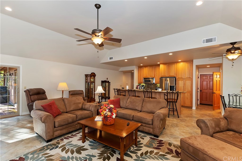 24310 Albrun Drive Crestline, CA 92325 - Photo 8 of 39 a living room with furniture a ceiling fan and a rug