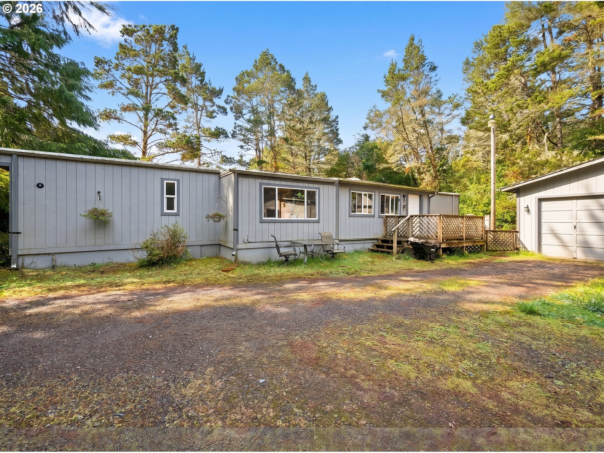 4826 Rhododendron Loop Florence, OR 97439 - Photo 5 of 41 a view of a house with backyard and a tree