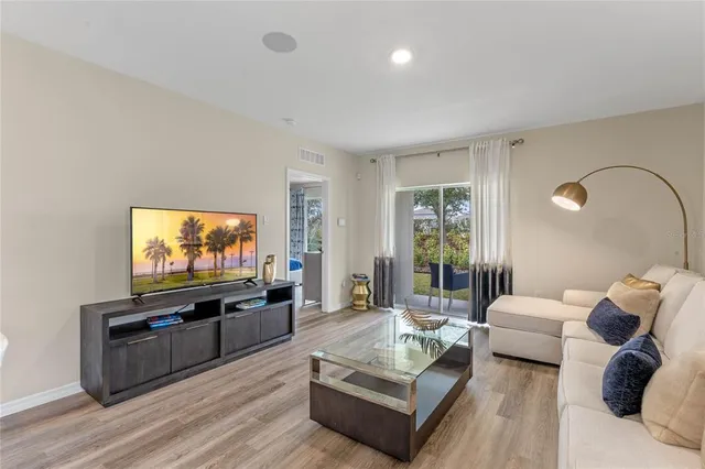 a living room with a bed furniture and a window