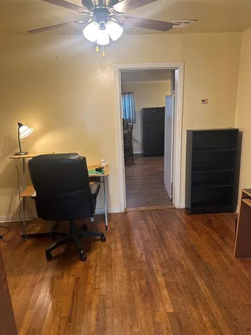 a view of a workspace with furniture and a chandelier