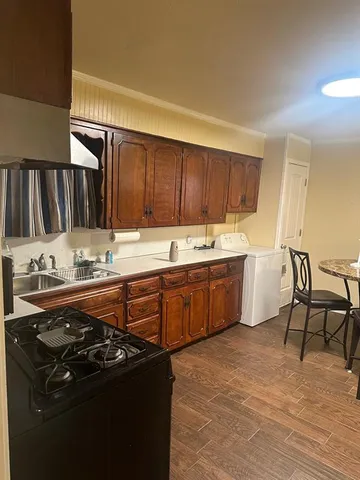 a kitchen with a stove a sink and a refrigerator