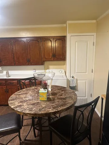 a view of a dining table and chairs in a kitchen