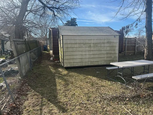 a view of a chairs and table in backyard