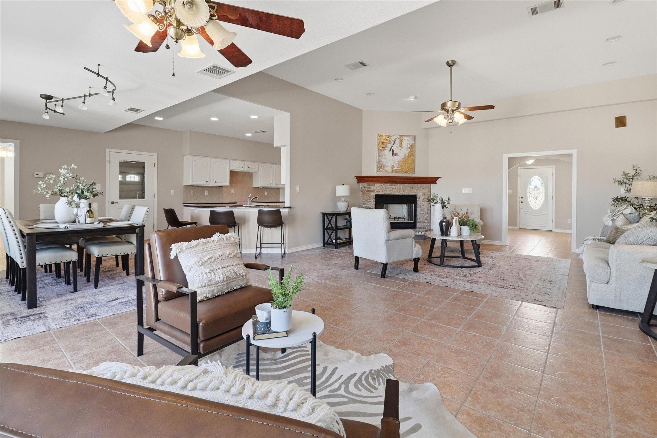200 Apache Trail Burnet, TX 78611 - Photo 13 of 40 Living room featuring a ceiling fan, a fireplace, and light tile patterned flooring