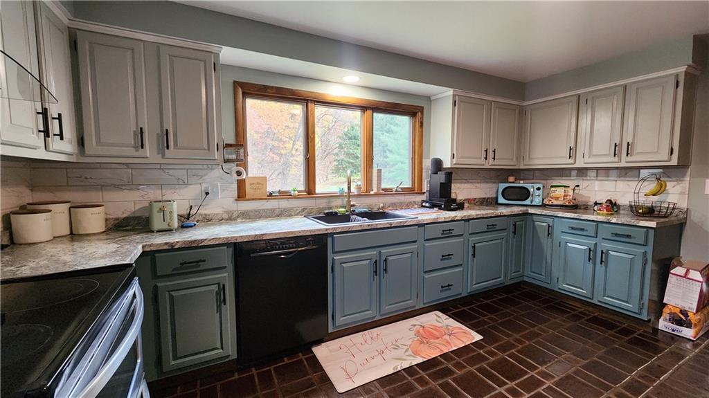 107 Spring Hollow Drive Apollo, PA 15613 - Photo 15 of 40 a kitchen with a sink stove top oven and cabinets