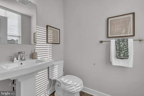 a bathroom with a toilet a sink and mirror