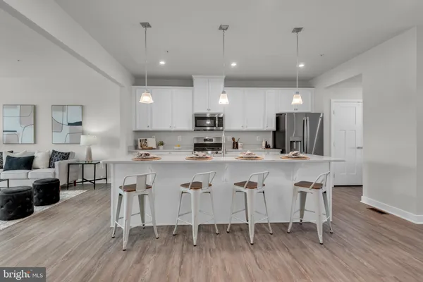 a large kitchen with a table and chairs
