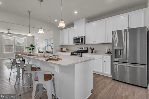 a kitchen with stainless steel appliances a refrigerator a stove a sink and a refrigerator