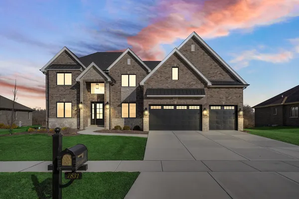 a front view of a house with a yard table and chairs
