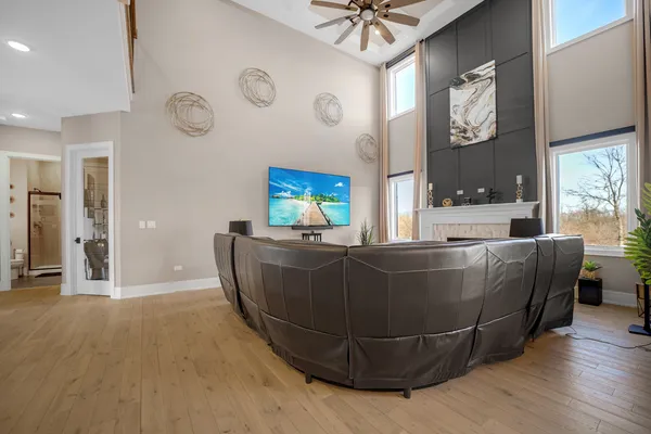 a living room with fireplace furniture and a chandelier