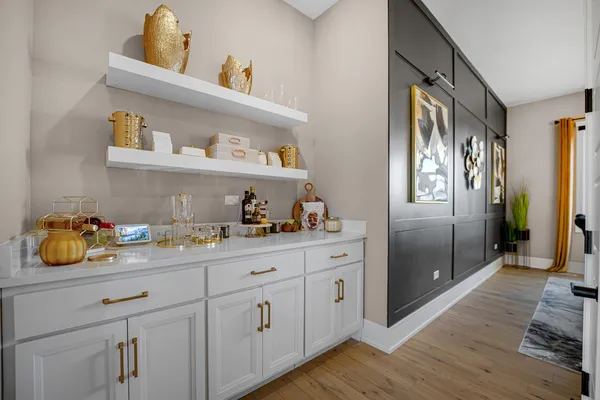 a kitchen with stainless steel appliances kitchen island granite countertop a refrigerator a stove a sink and a dining table with wooden floor