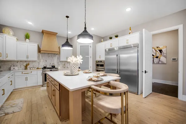 a kitchen with stainless steel appliances cabinets a stove and a refrigerator