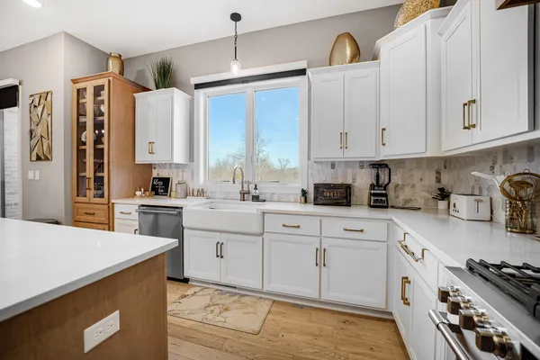 a view of a hallway with wooden floor and windows