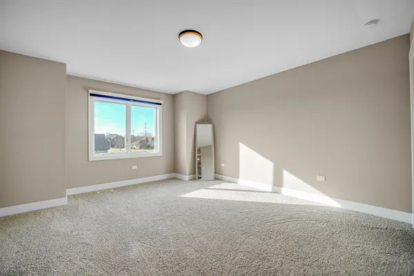 an empty room with windows and closet