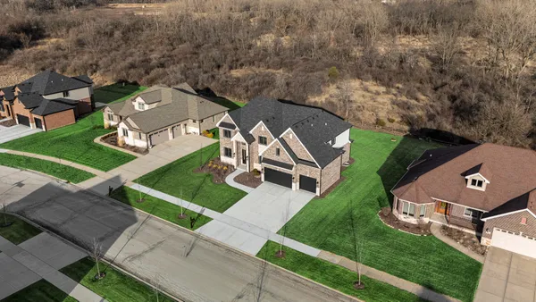 an aerial view of a house with a garden and trees