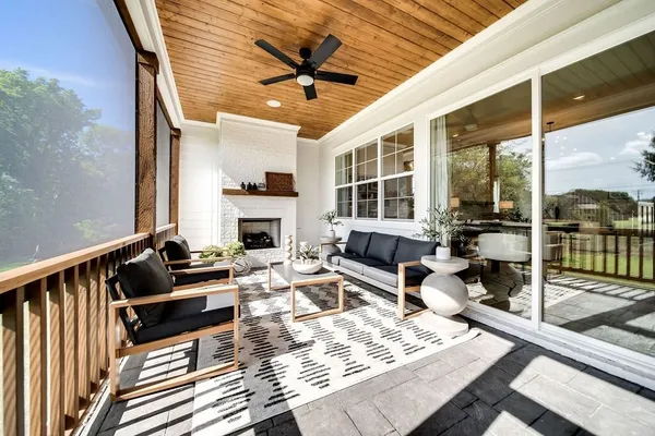 a living room with fireplace furniture and a large window