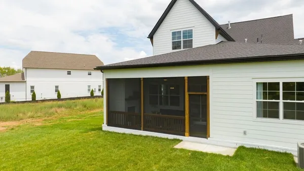 a bedroom with furniture and a large window