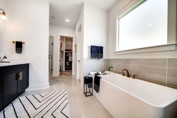 a en suite bathroom with a sink double vanity granite and a mirror