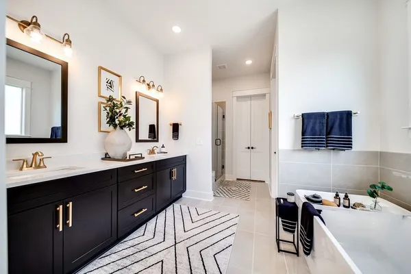 a bathroom with a bathtub sink and mirror