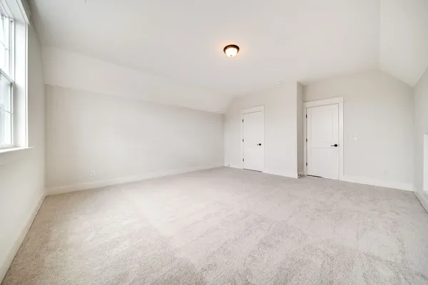 an empty room with windows and closet
