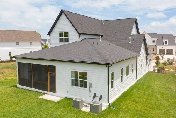 a view of house with yard and front view of a house