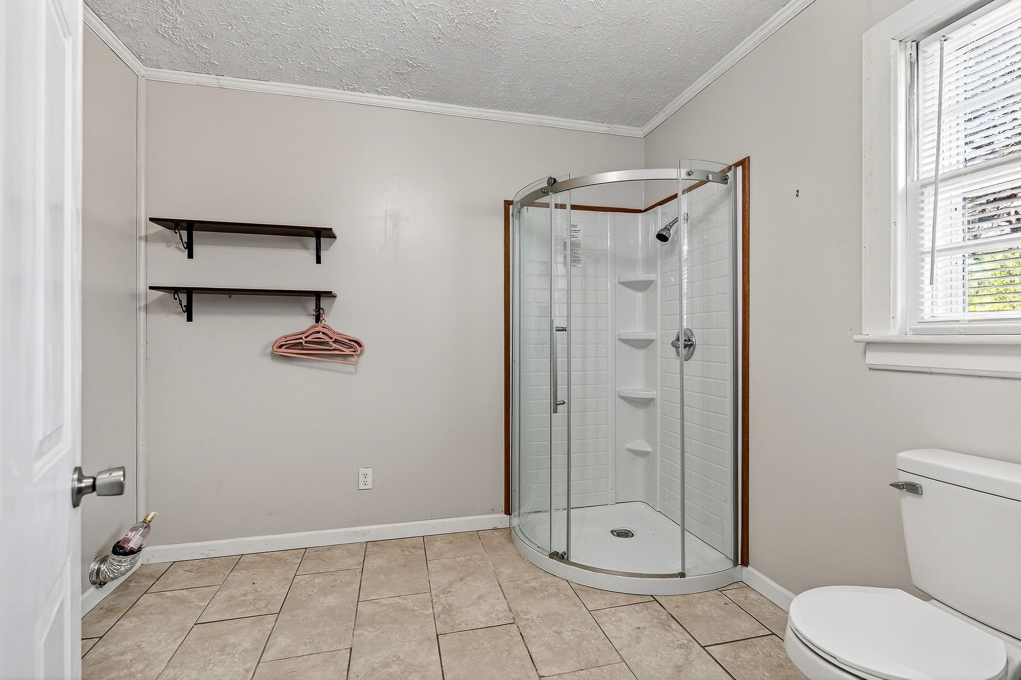 111 Roosevelt Road McMinnville, TN 37110 - Photo 19 of 27 a bathroom with a glass shower door