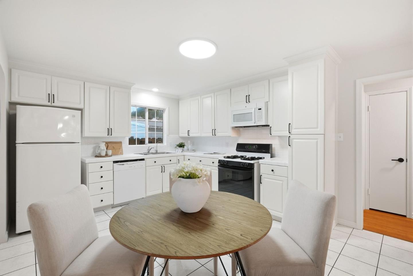 320 Angel Avenue Sunnyvale, CA 94086 - Photo 19 of 47 a kitchen with white cabinets and stainless steel appliances