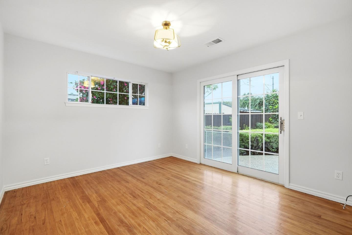 320 Angel Avenue Sunnyvale, CA 94086 - Photo 23 of 47 a view of an empty room with wooden floor and a window
