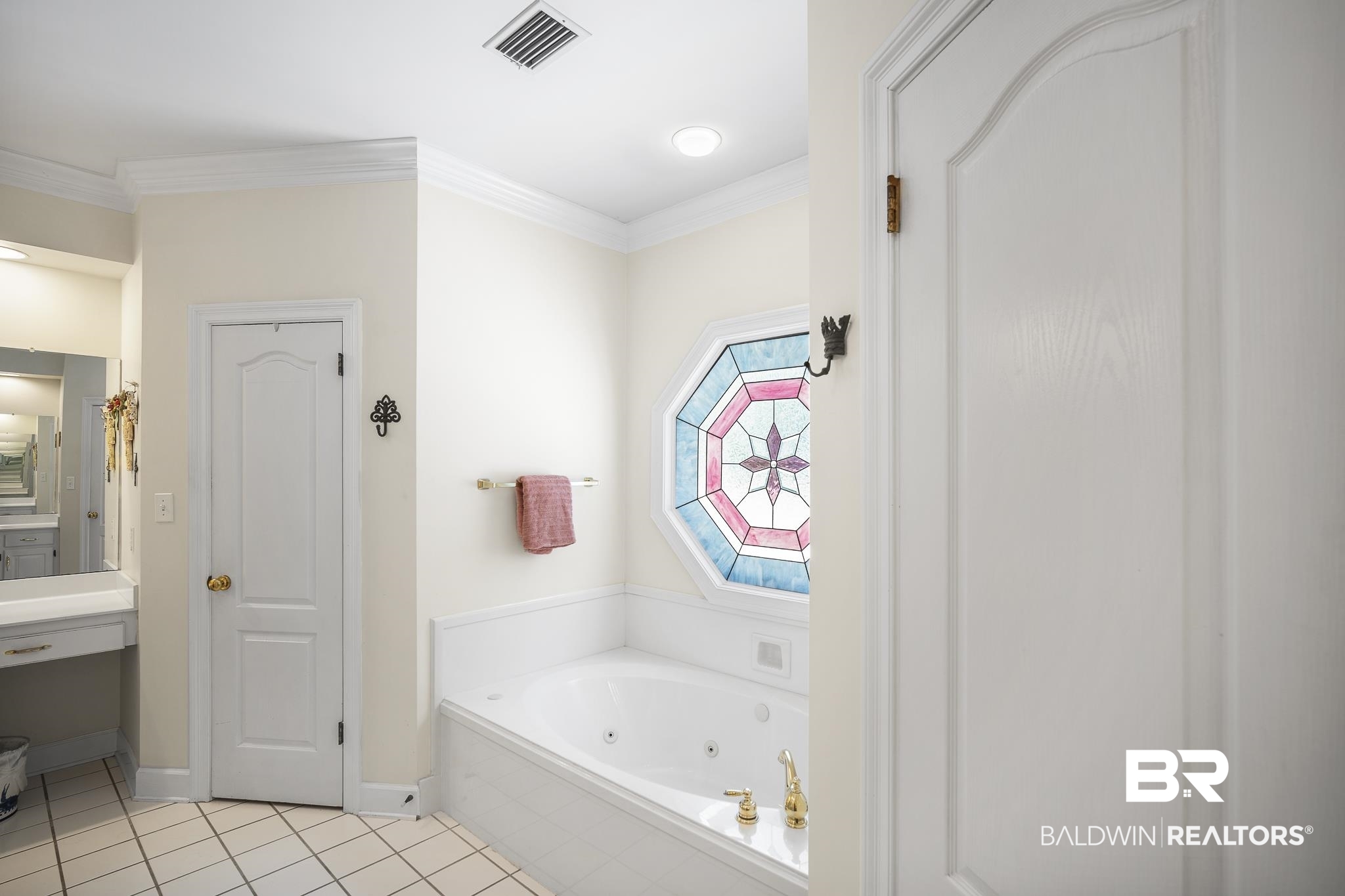 402 Potters Mills Road Daphne, AL 36526 - Photo 27 of 45 Full bath featuring tile patterned flooring, a whirlpool tub, baseboards, and crown molding