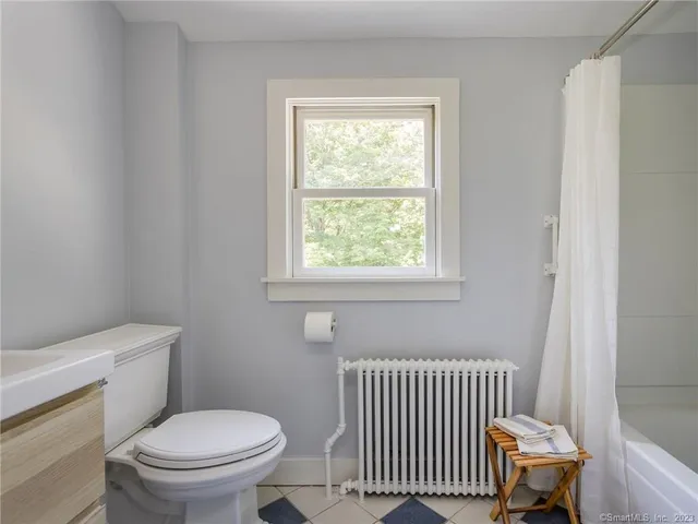 a bathroom with a toilet and a window