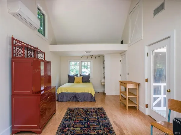 a bedroom with a bed and wooden floor