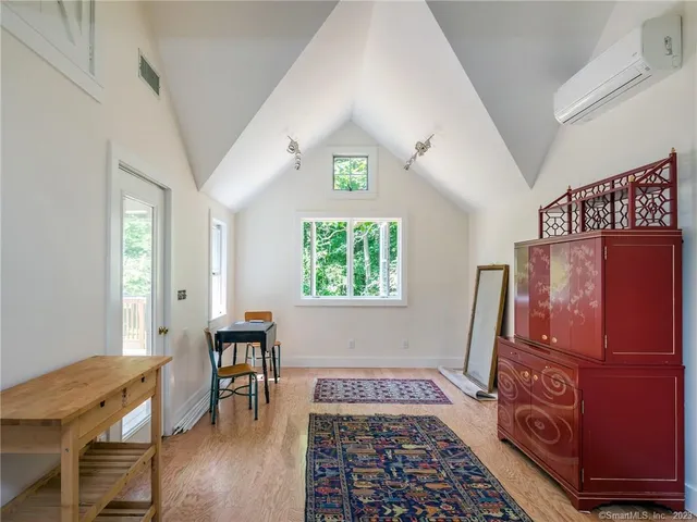 a bedroom with furniture and a window