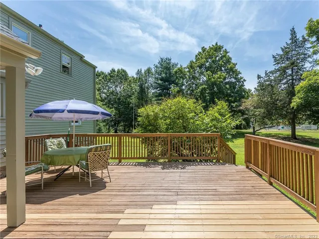 a view of a deck with furniture and backyard