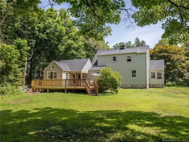 a front view of a house with yard and green space