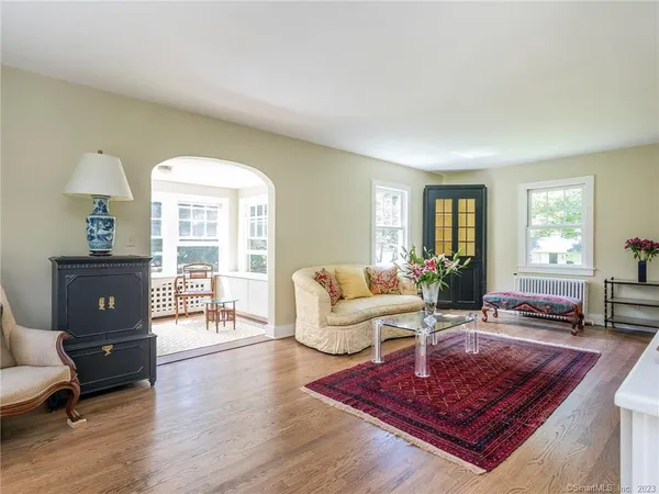 a living room with furniture rug and window
