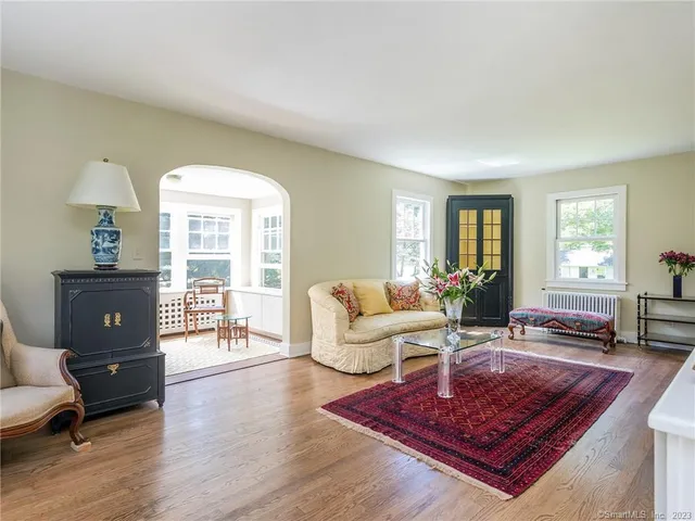 a living room with furniture rug and window